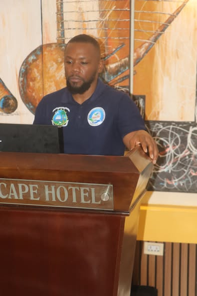 Speaker addresses participants from a podium at a social protection event